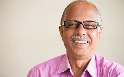 Elderly man smiling after Macular Degeneration treatment