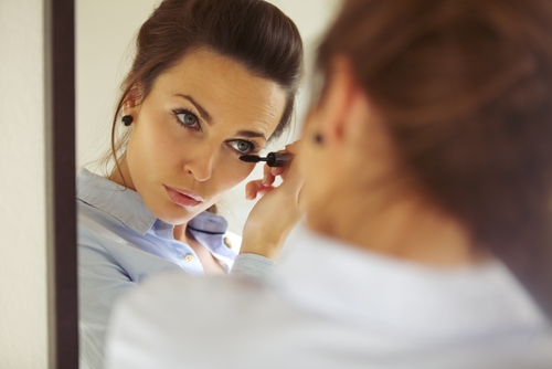 Young woman using makeup after LASIK