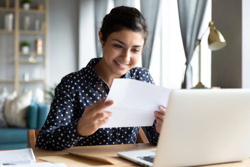 Woman smiling at a piece of paper