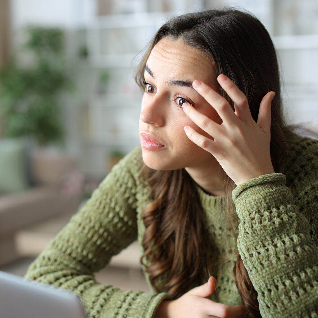 Woman pulling down her lower eyelid to check her eye