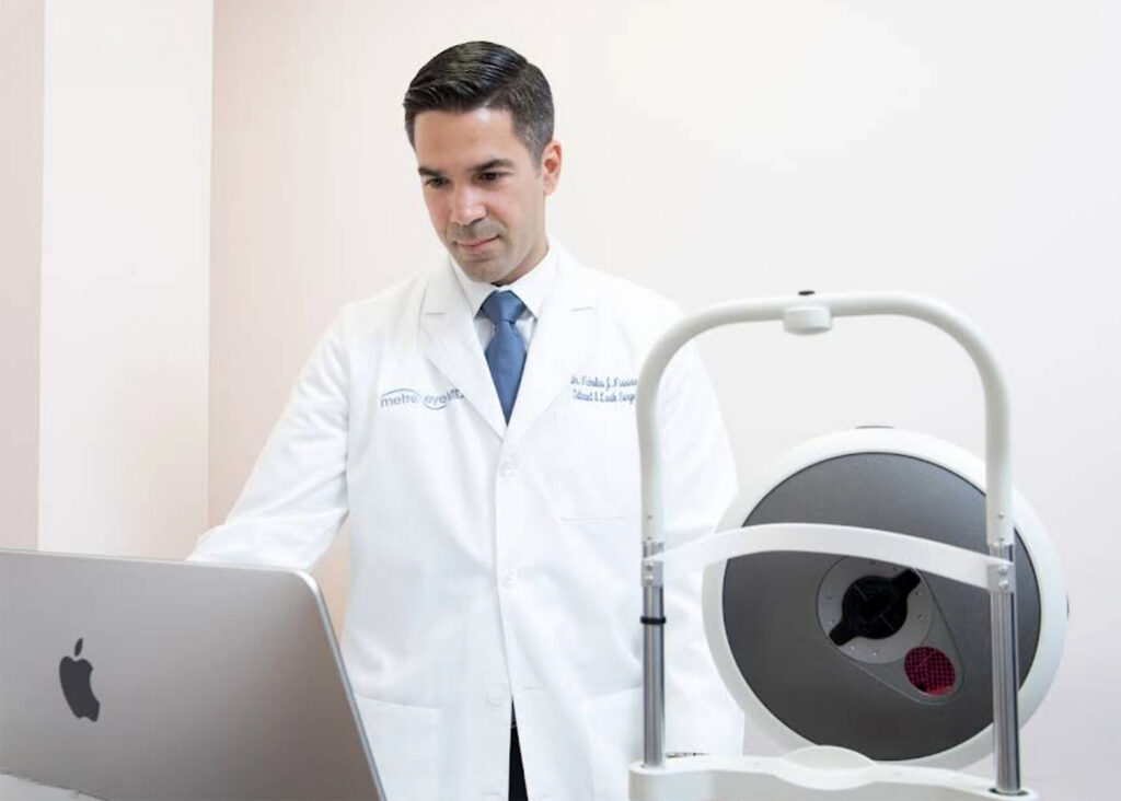 Metro Eye MD doctor in a white coat beside eye exam equipment